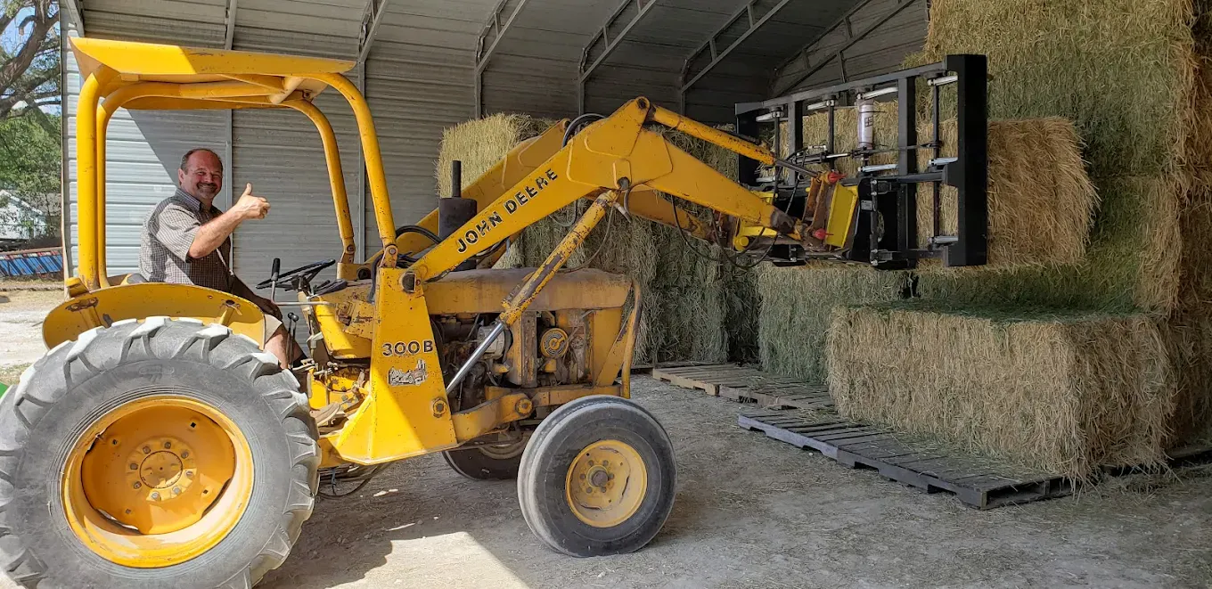 John Deere forklift moving hay bales at Farmers Direct Hay and Feed