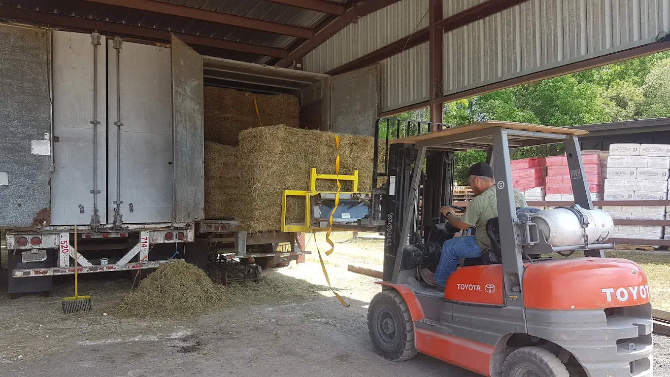 Unloading hay from semi trailer into the warehouse